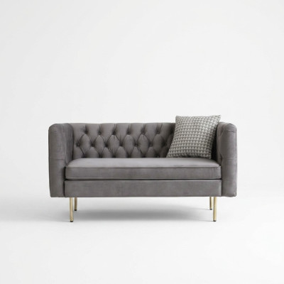 Mebel w stylu angielskim Chesterfield dwuosobowa sofa różowo-turkusowo-żółto-niebieska.